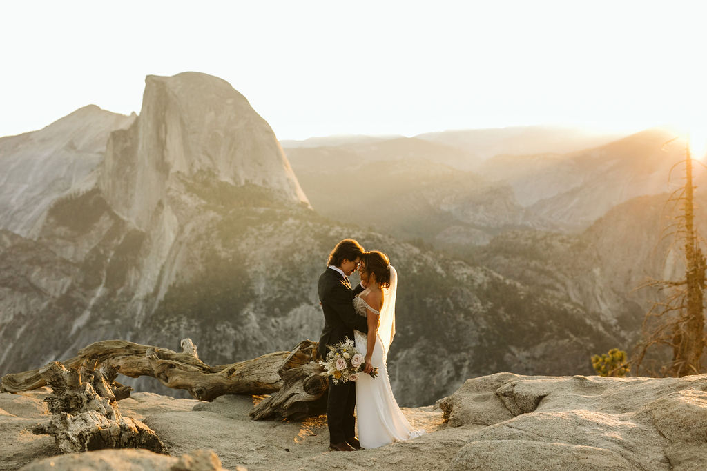 A bride and groom at Observation Point at Yosemite National Park at sunrise for an adventure elopement photoshoot with photographer Kelly Lemon