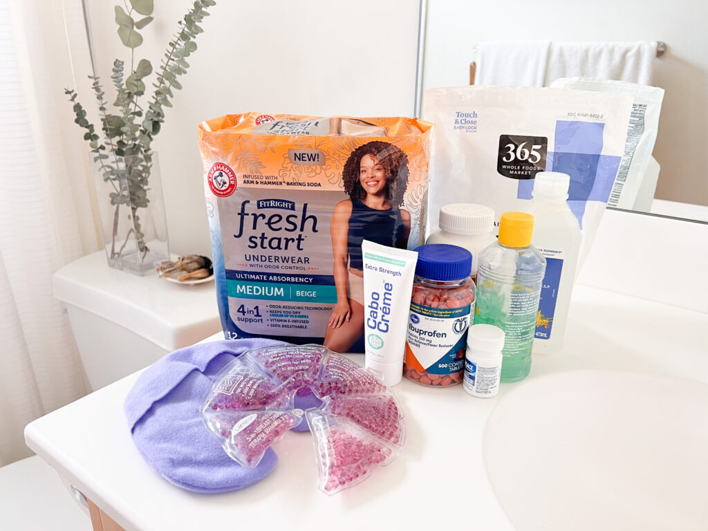 a spread of postpartum care supplies displayed in a woman's bathroom